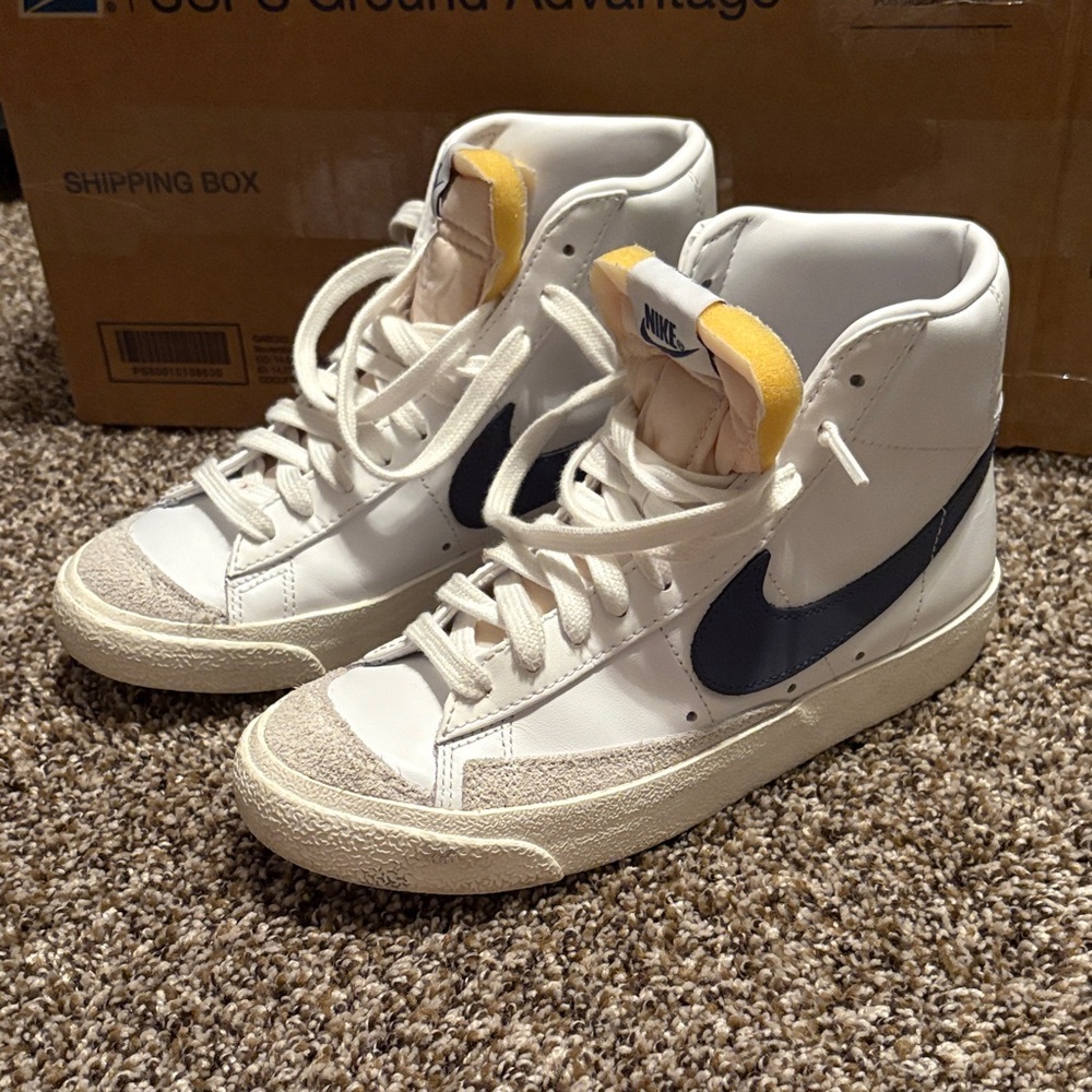 Nike White High-Top Sneakers with Navy Swoosh and Yellow Tongue Accent